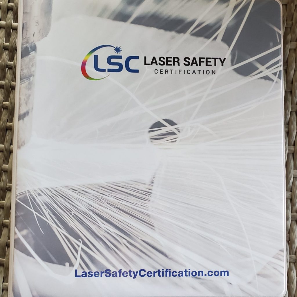 the laser safety certificate is displayed on a table.