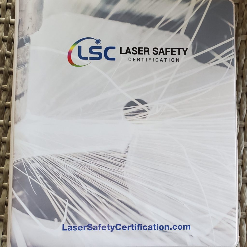 the laser safety certificate is displayed on a table.