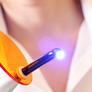 a close up of a person holding a toothbrush.