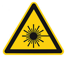 a yellow and black triangle sign with a sun burst.