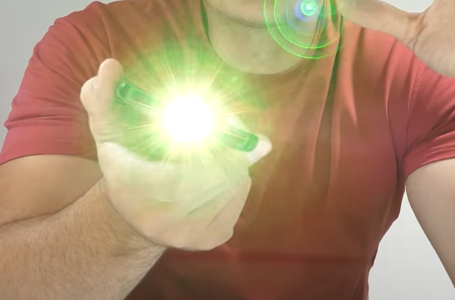 a man in a red shirt holding a green light.