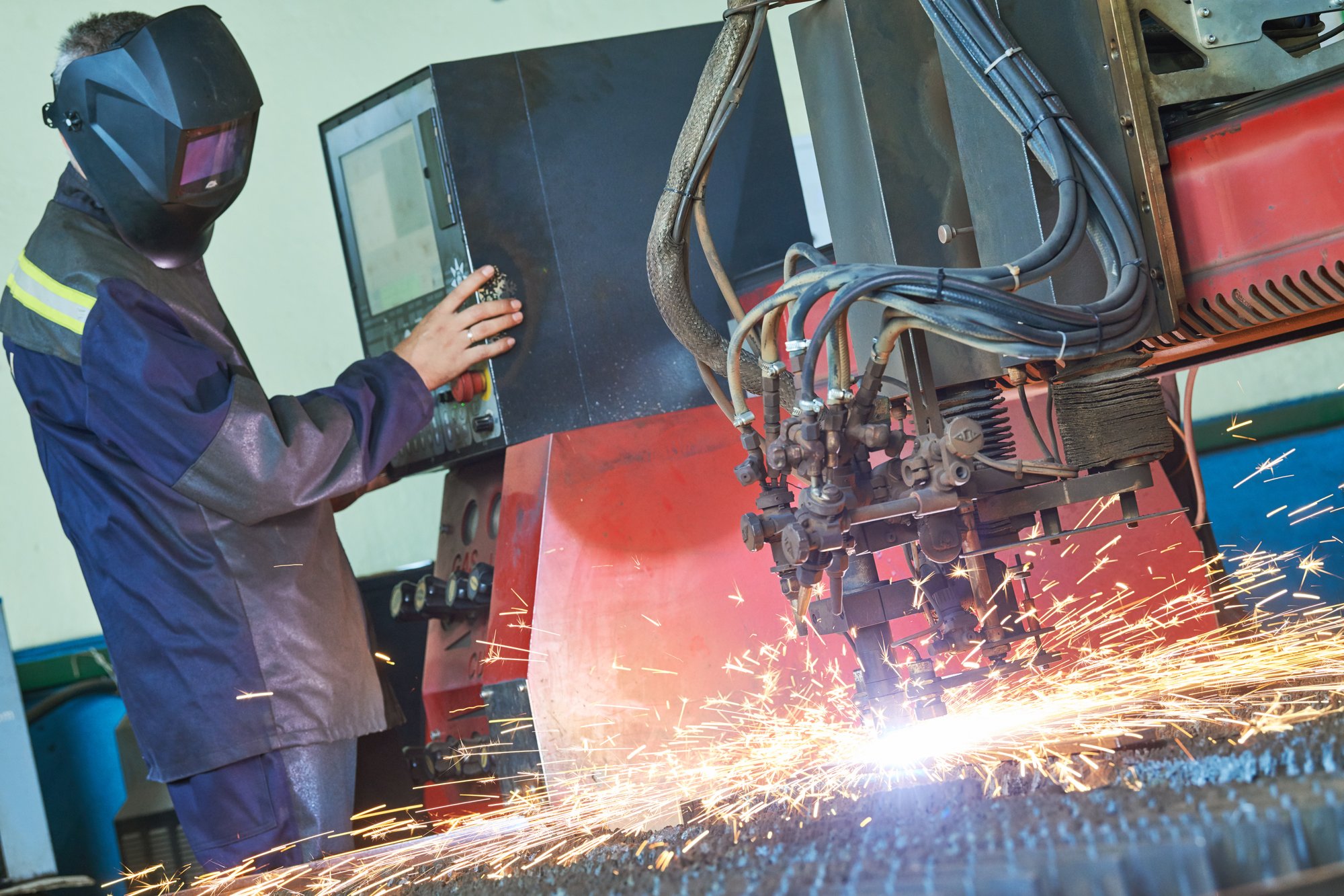 a man working on a machine in a factory.