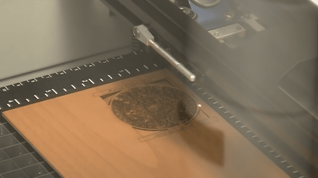 A piece of wood being laser engraved.