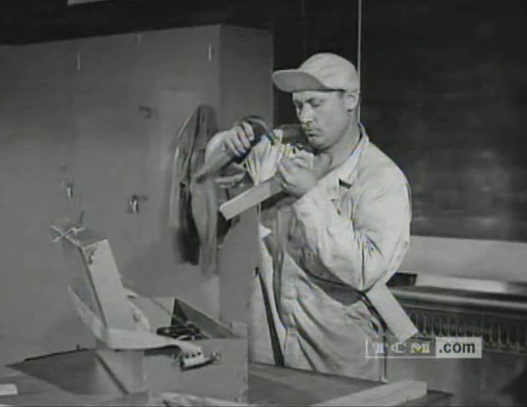 A man working on a machine in compliance with OSHA industrial safety.