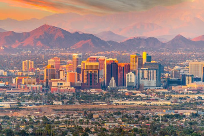 a view of a city with mountains in the background.