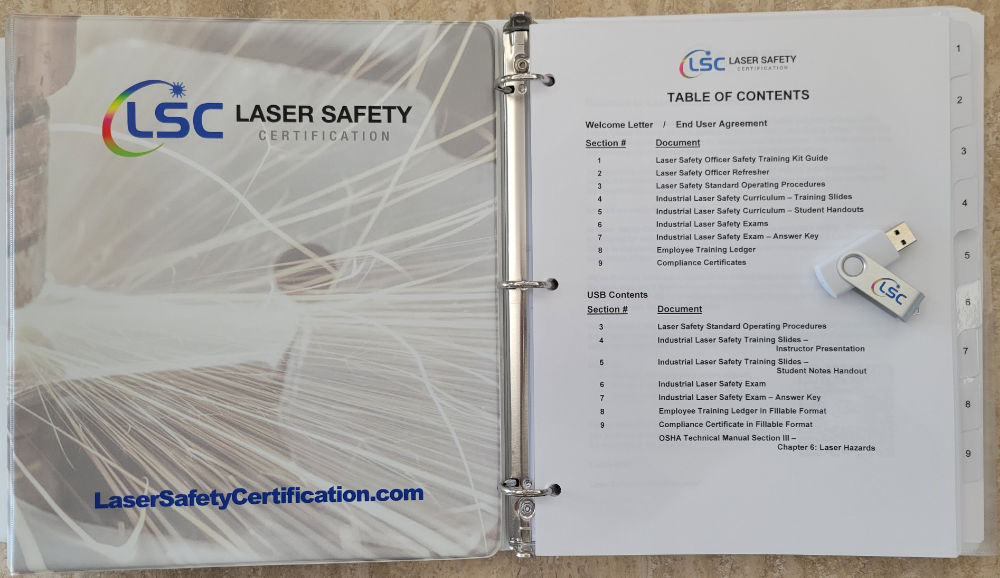 A binder with a certified laser safety officer training certificate and a usb drive.